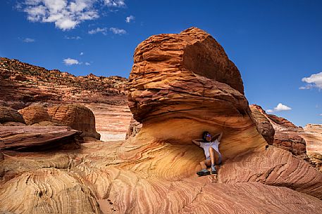 Girl at The Wave. It is a sandstone rock formation  located in Arizona close to  the Utah border, Paria Canyon-Vermilion Cliffs Wilderness, United States