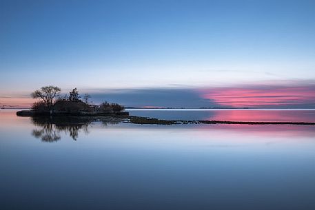 Sunset in the islet with Casone, a typical building of Grado e Marano Lagoon, Adriatic sea, Friuli Venezia Giulia, Italy
