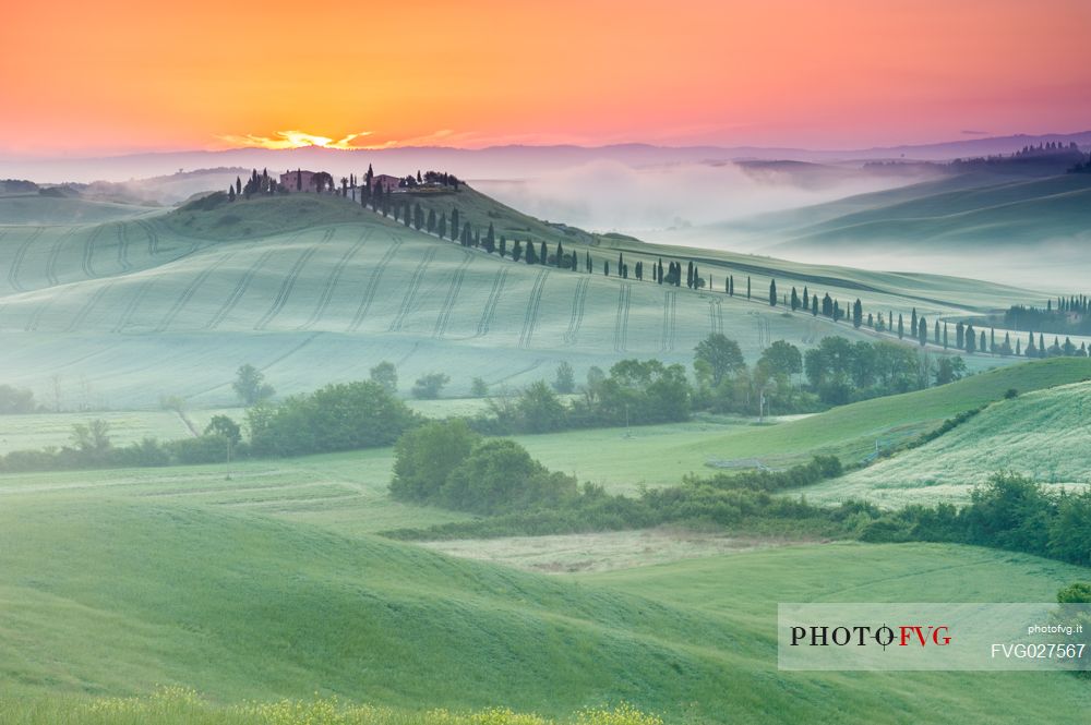 Farm in the Crete Senesi landscape at sunset, Orcia valley, Tuscany, Italy