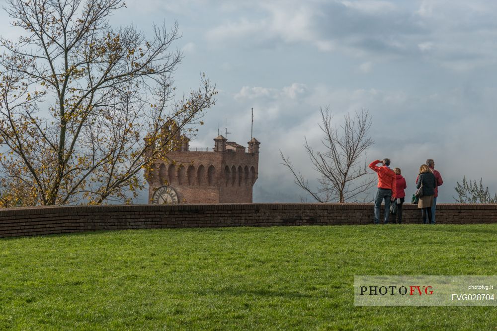 Tourists looking the Torre di Matilde tower form the torre Federico II tower in San Miniato, Tuscany, Italy