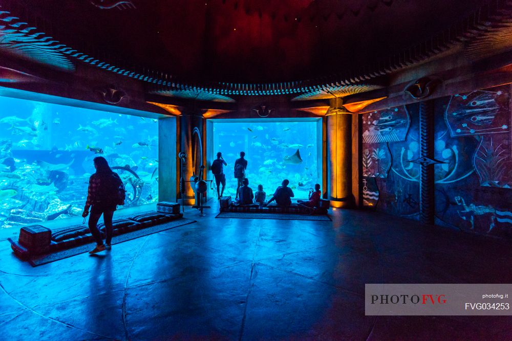 Visitors watching the aquarium in the Atlantis Hotel on the Jumeirah Palm island, Dubai city, United Arab Emirates, Asia