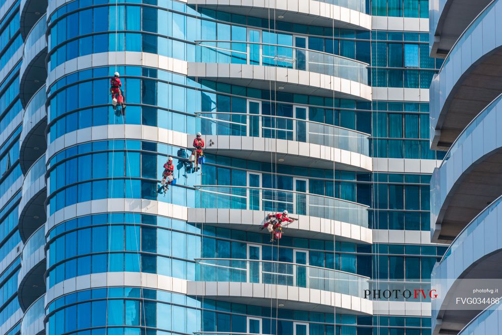 Window cleaners on skyscrapers of Abu Dhabi city, Emirate of Abu Dhabi, United Arab Emirates, UAE