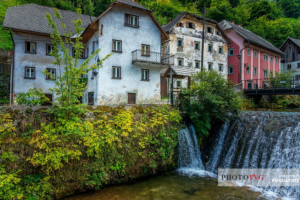 River and traditional houses in the Kropa village, Radovljica, Slovenia, Europe