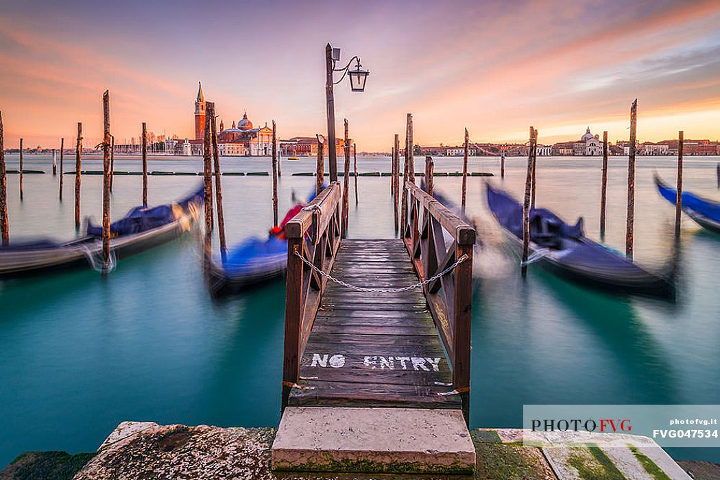 Moored gondolas in front of San Giorgio Maggiore church, view from San Marco square, Venice, Veneto, Italy