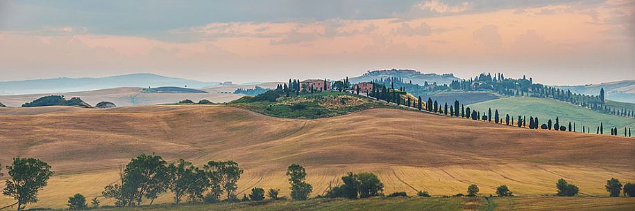 Farm in the Crete Senesi landscape at sunrise, Orcia valley, Tuscany, Italy