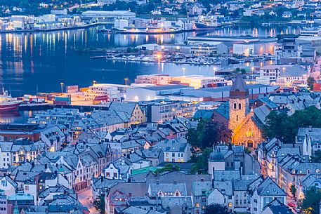 View from Aksla mountain towards Alesund old town and harbour illuminated at dusk, Norway