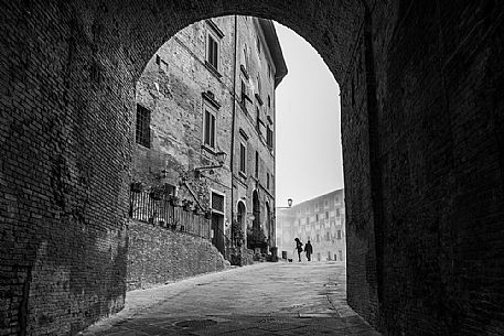 Gate in the Piazza del Seminario square, in the background the episcopal seminary of San Miniato village, Tuscany, Italy