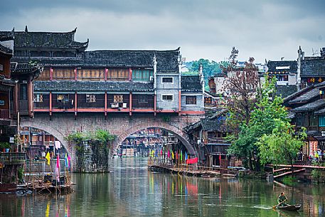 Sailing along Tuojiang river, Phoenix Hong Bridge or Rainbow bridge in Fenghuang ancient town, Hunan, China