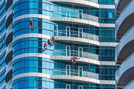 Window cleaners on skyscrapers of Abu Dhabi city, Emirate of Abu Dhabi, United Arab Emirates, UAE