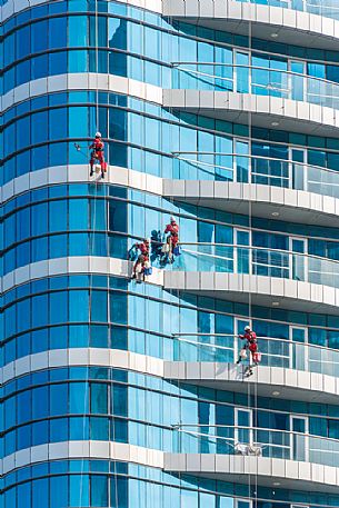 Window cleaners on skyscrapers of Abu Dhabi city, Emirate of Abu Dhabi, United Arab Emirates, UAE