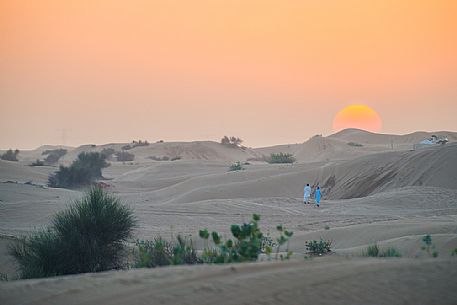 Arab men in the desert at sunset, Dubai, United Arab Emirates, Asia