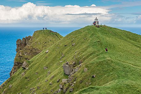 Tourists at Kallur Lighthouse, Kalsoy Island (Kalsø), Faeroe Islands, Denmark, Europe