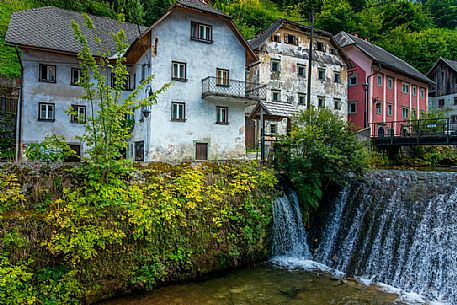 River and traditional houses in the Kropa village, Radovljica, Slovenia, Europe