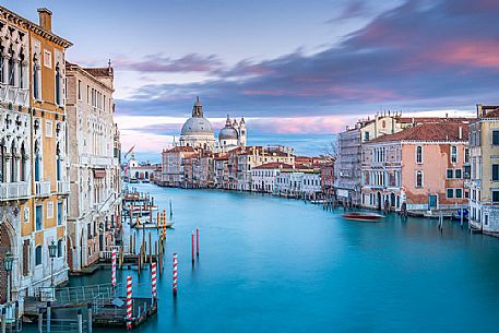 Palazzo Cavalli Franchetti in the Grand Canal and in the background the Santa Maria della Salute church from Accademia bridge at sunset, Venice, Italy, Europe