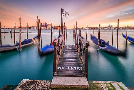 Moored gondolas in front of San Giorgio Maggiore church, view from San Marco square, Venice, Veneto, Italy