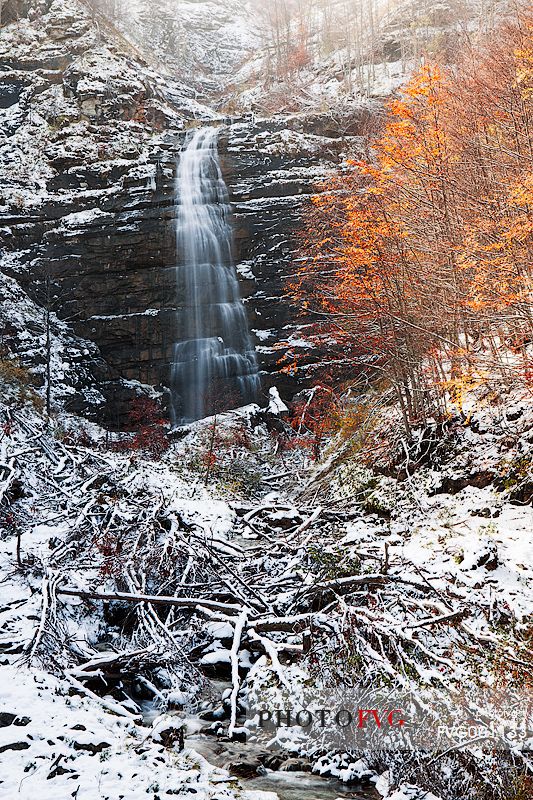 The Morricana Waterfal flow in the silence of a snow covered woods. The river bed is littered with debris legacy of a great avalanche of the previous winter, Gran Sasso and Monti della Laga national park