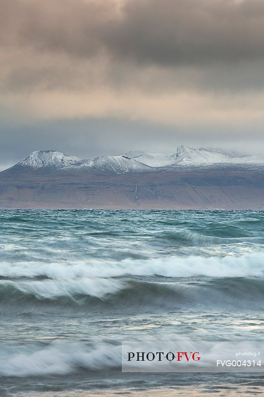 Stormy sea and mountains in the background