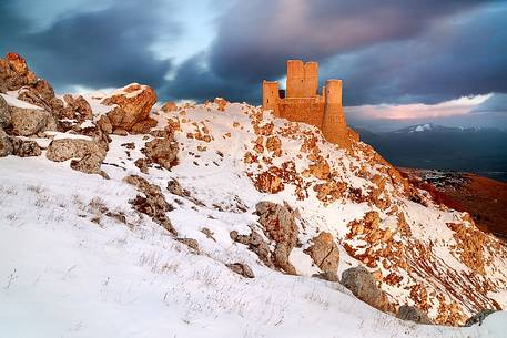The castle of Rocca Calascio stands on a limestone spur, surrounded by highest peaks of the Apennines, Gran Sasso and Monti della Laga national park