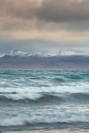 Stormy sea and mountains in the background